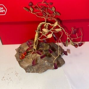 Man under stone and wire tree resting on crystal chunk